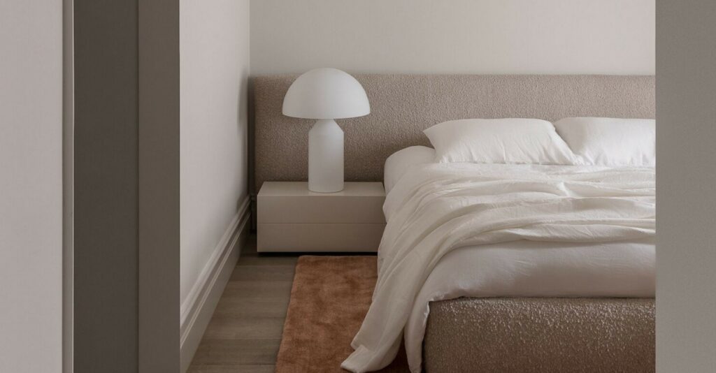 cosy neutral bedroom design with white statement lamp