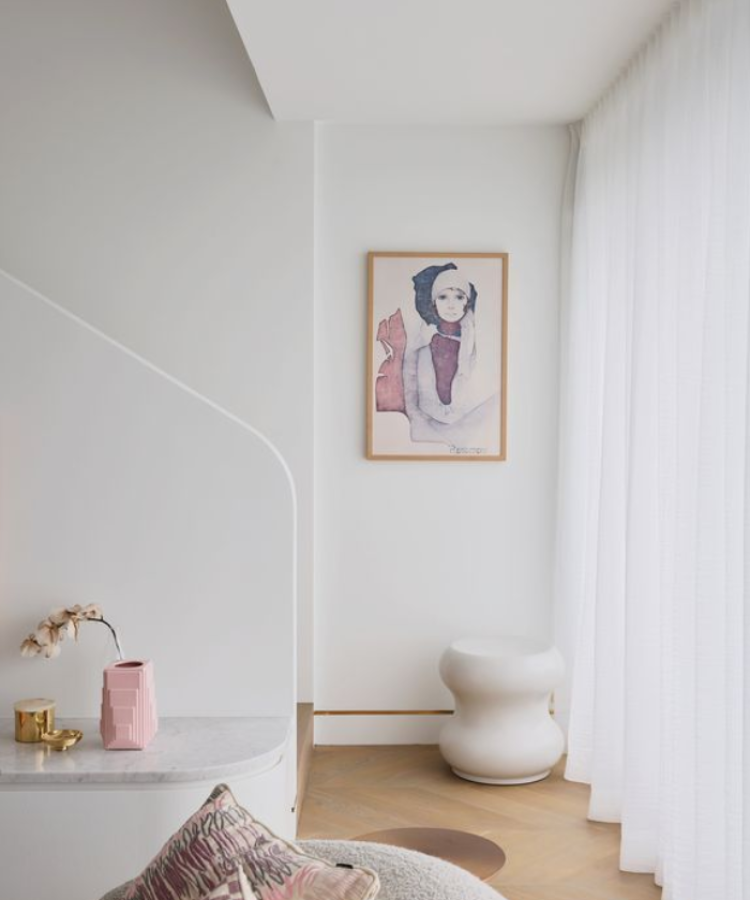 living room passage with artwork and a stool